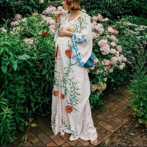 White maxi dress with colorful embroidery - for maternity pregnancy photos.